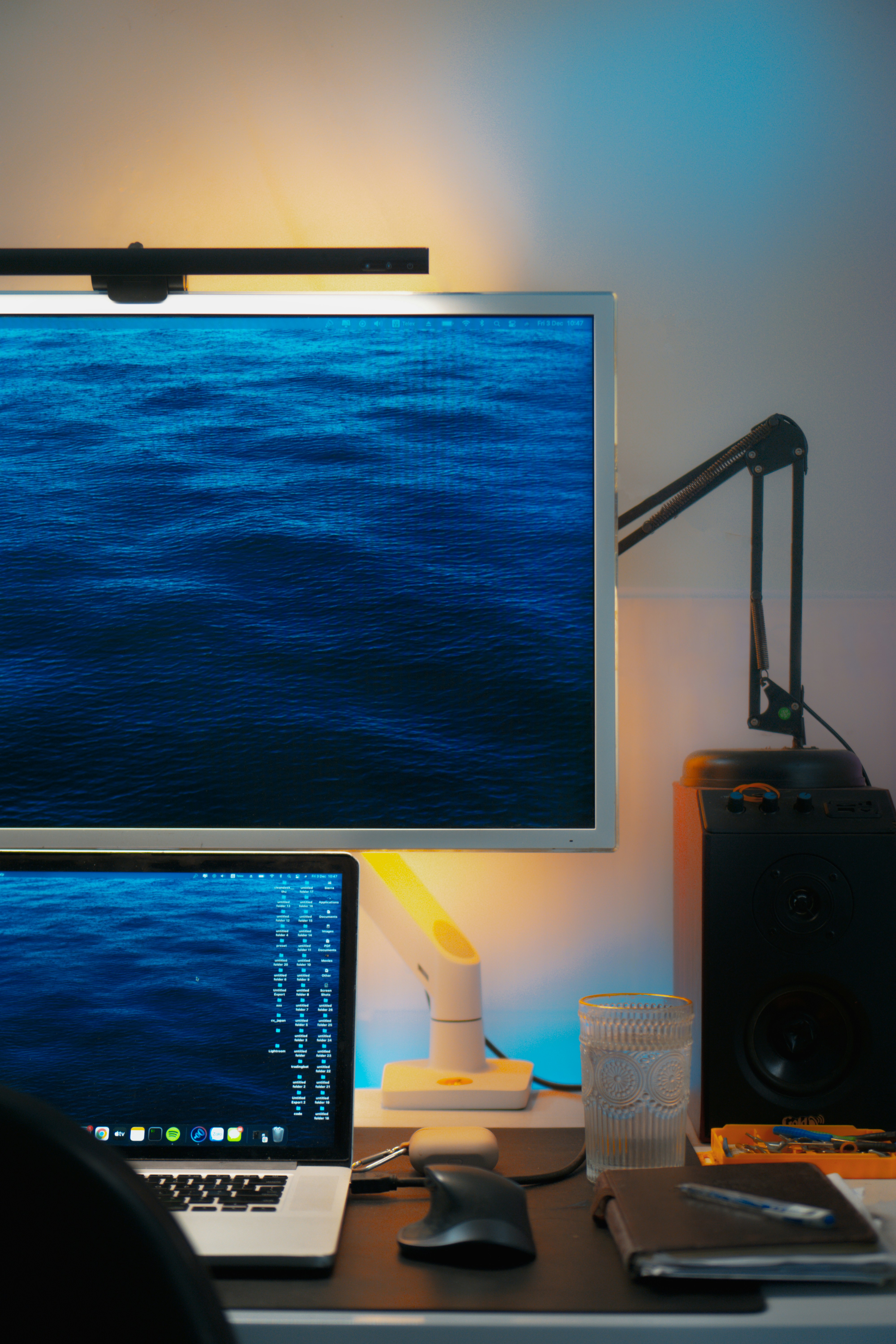 a desk with a monitor and a laptop on it