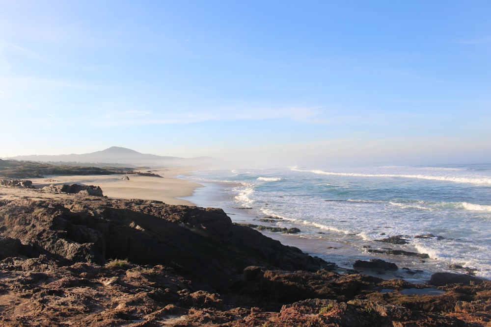 a view of the ocean from a rocky shore