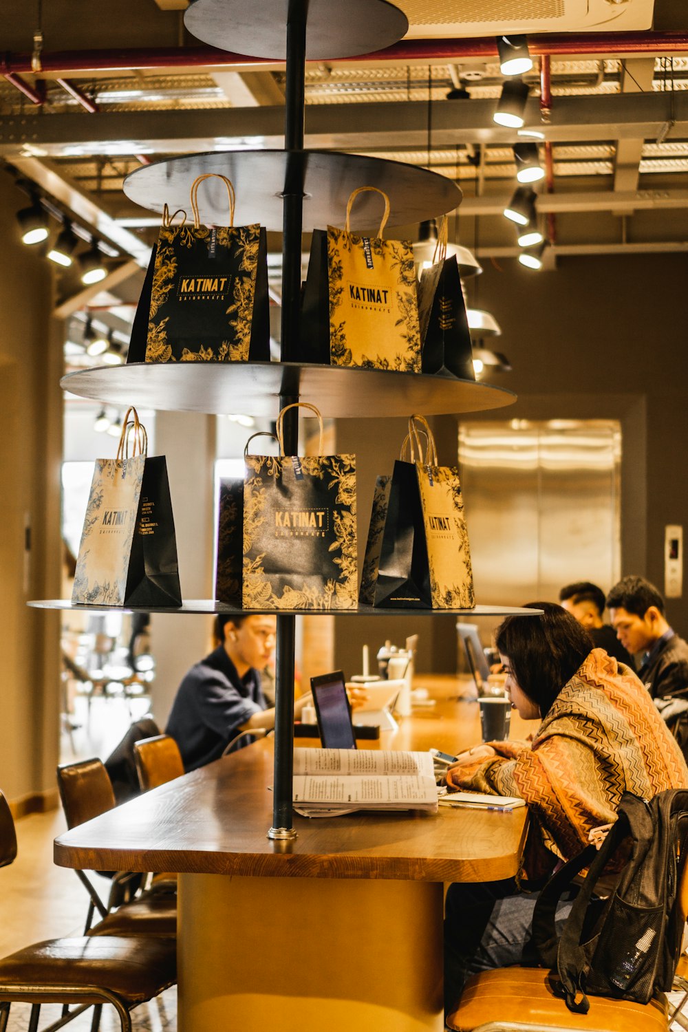 a group of people sitting at a table in a restaurant