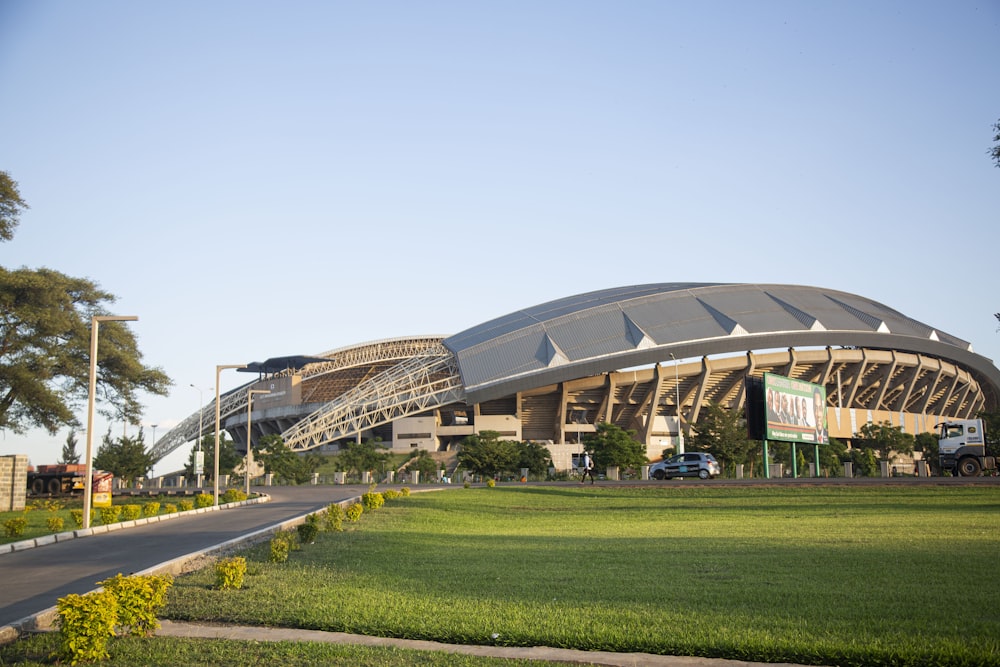 a large stadium with a green field in front of it