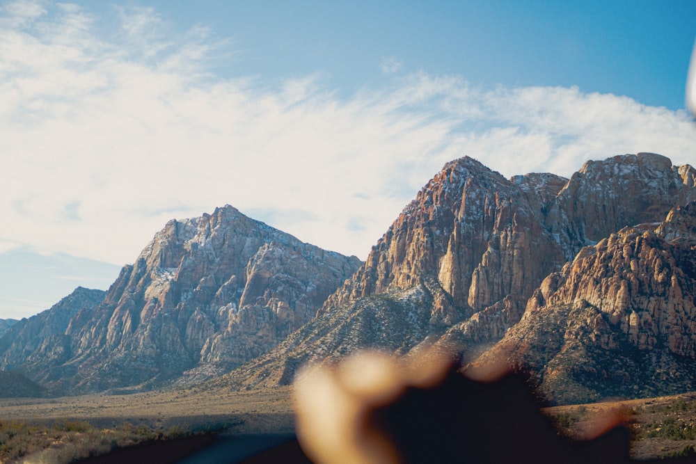 a view of a mountain range from a vehicle