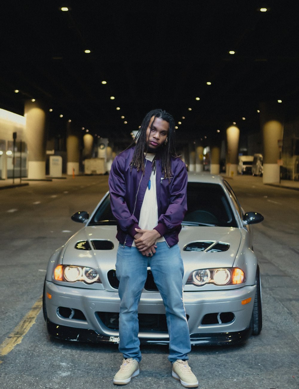 a man sitting on the hood of a car