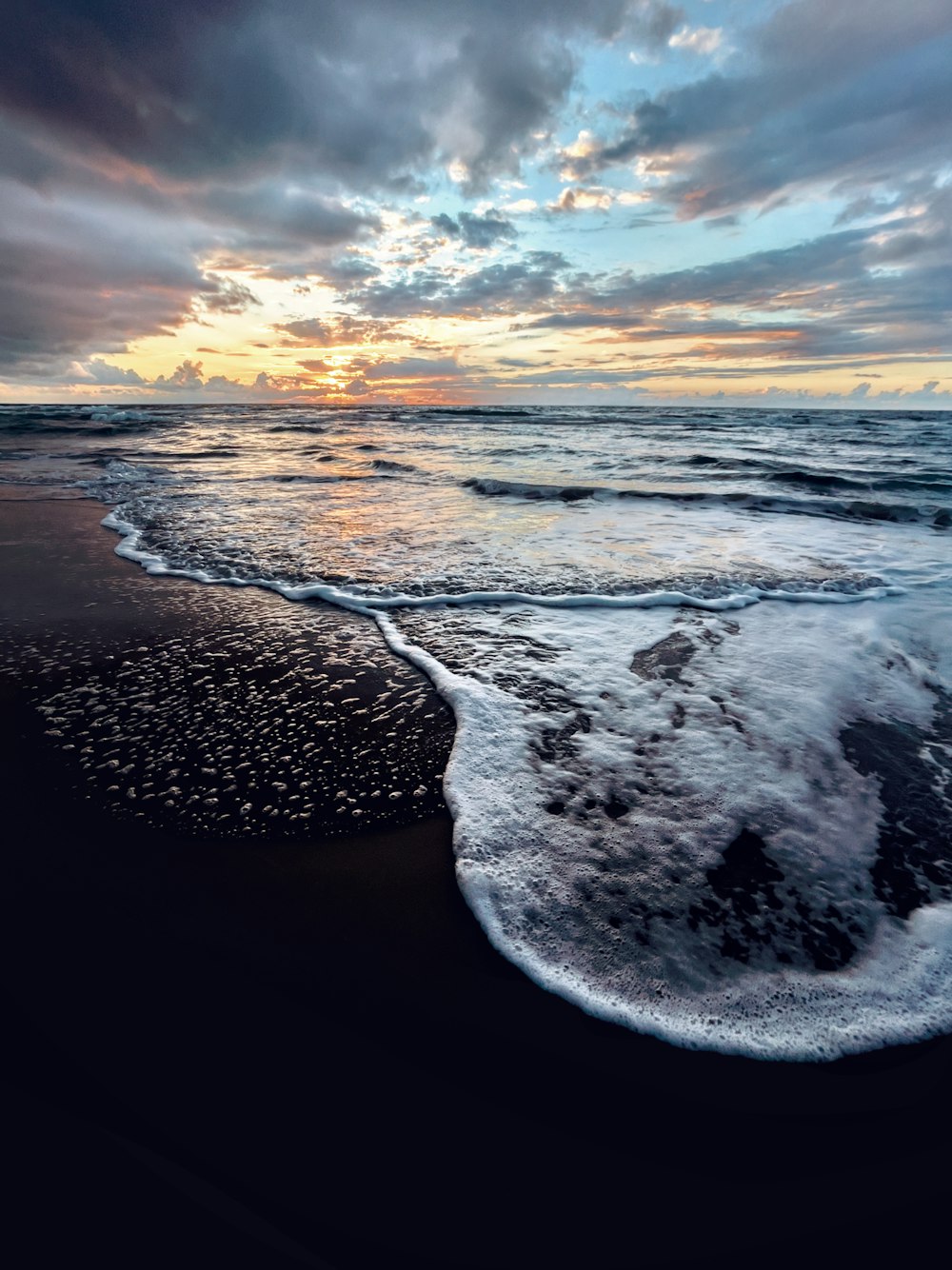 a beach with waves coming in to shore