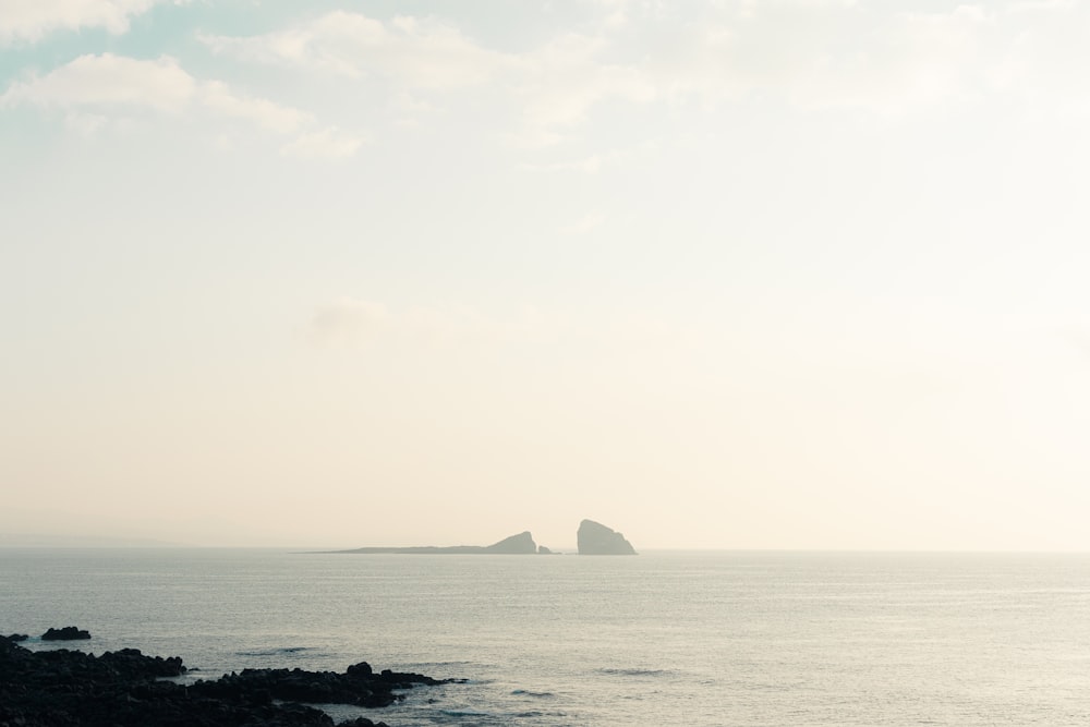 a large body of water with a small island in the distance