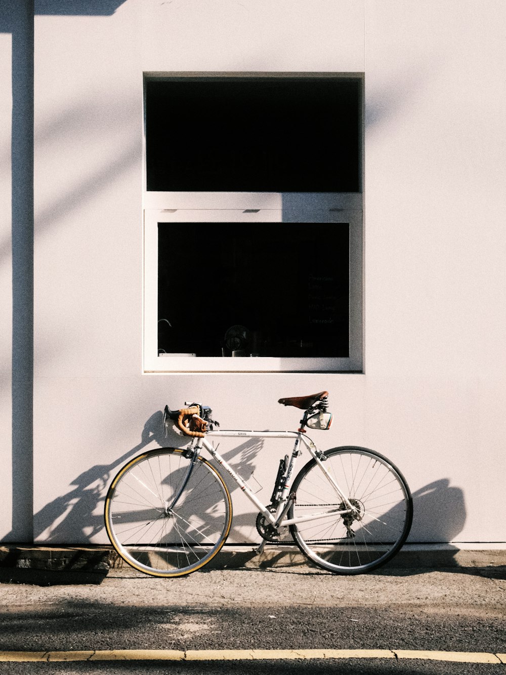 a bike parked next to a white building