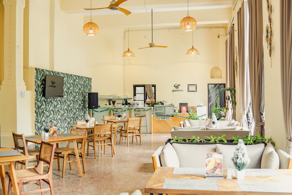 a restaurant with tables and chairs and a ceiling fan