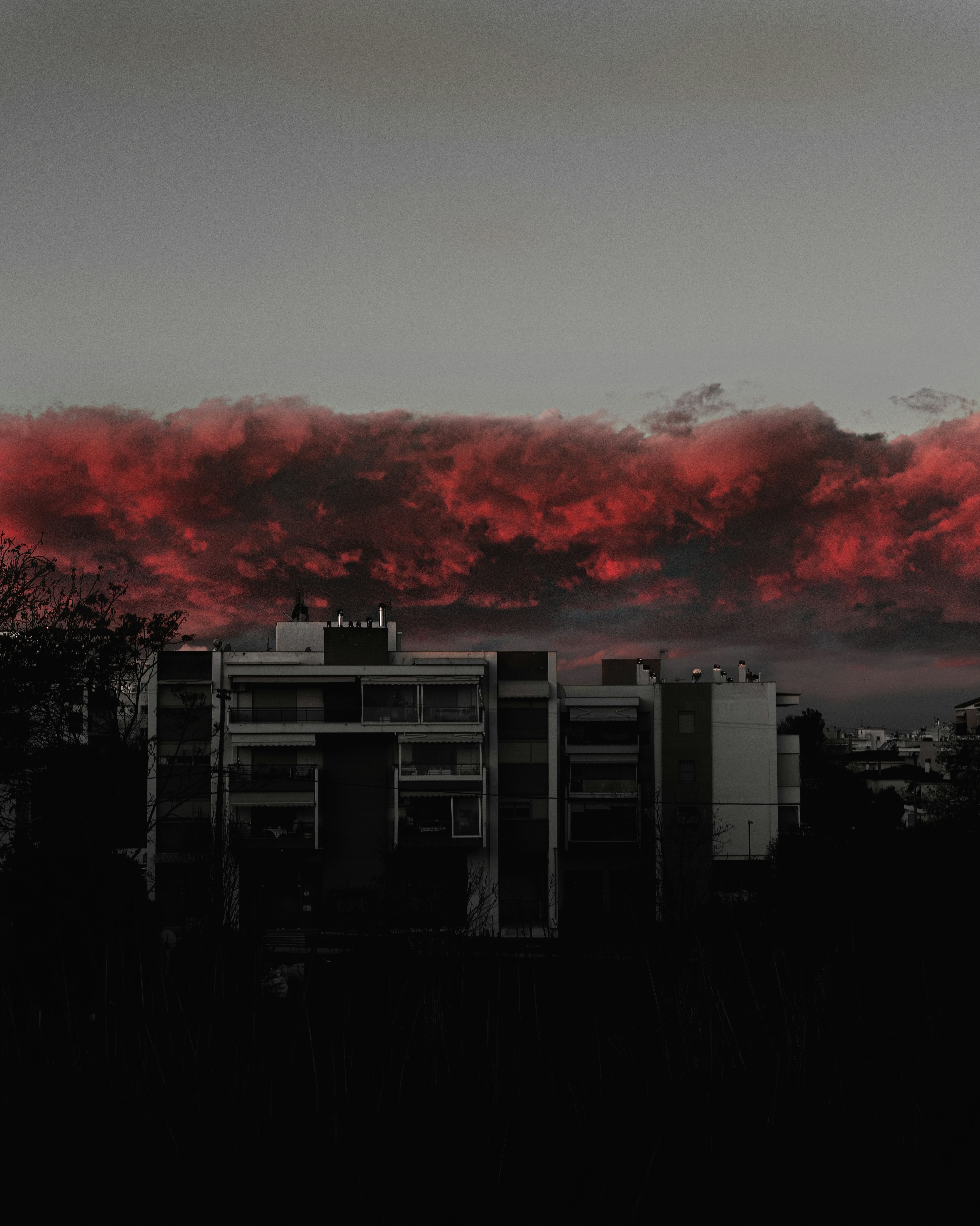 a red cloud is in the sky over a city
