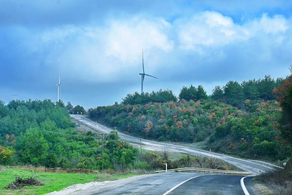 a wind turbine on the side of a road