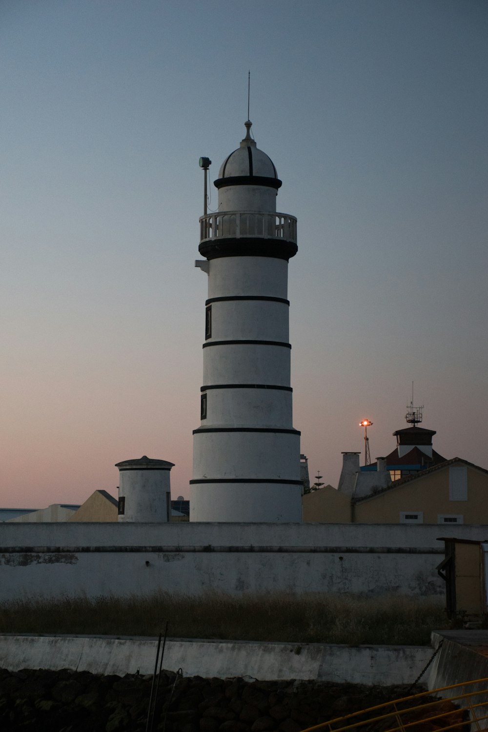 a large white and black lighthouse on top of a building