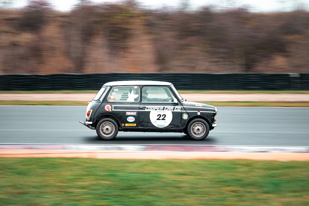 a small car driving down a race track