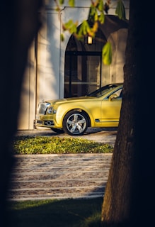 a yellow car parked in front of a building