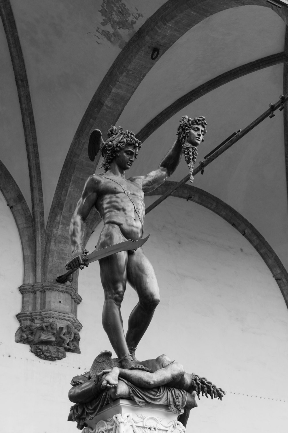 a black and white photo of a statue