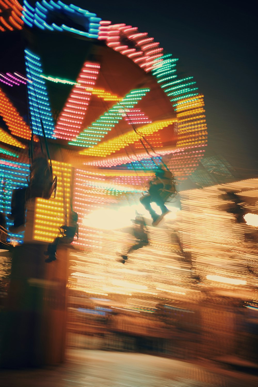 a blurry photo of a carnival ride at night