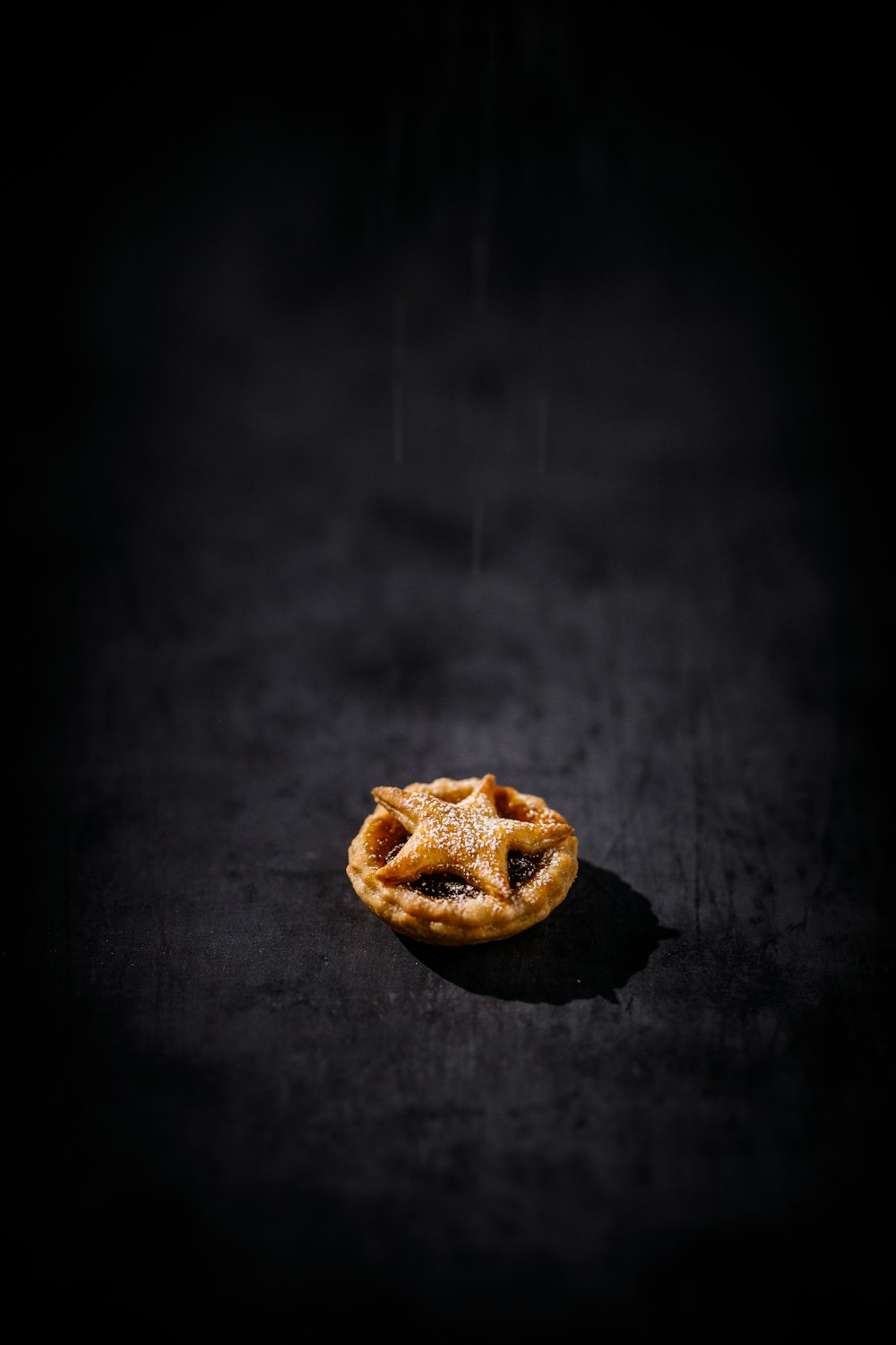 a piece of pie sitting on top of a black surface