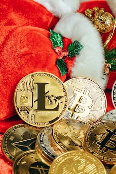 a pile of gold bitcoins and a santa hat