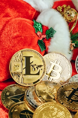 a pile of gold bitcoins and a santa hat