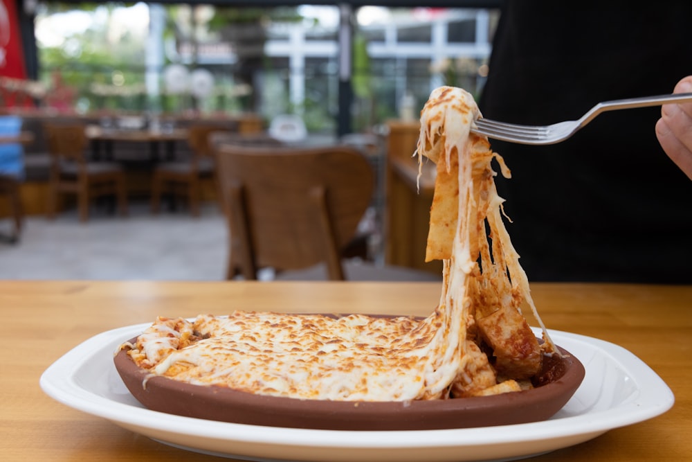 a person eating a plate of food with a fork