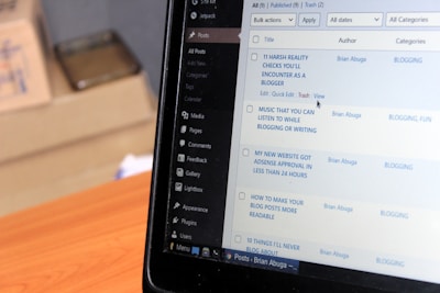 a laptop computer sitting on top of a wooden desk