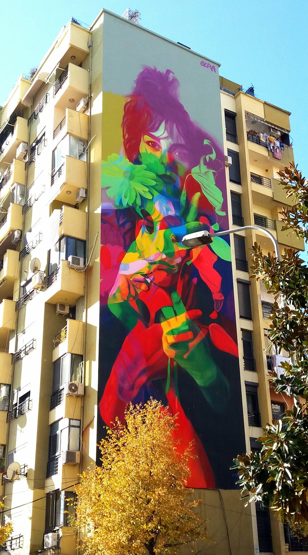 a tall building with a colorful mural on the side of it