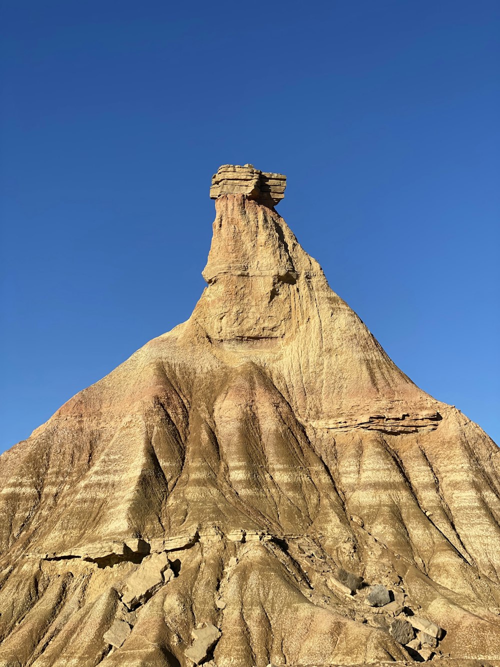 a very tall mountain with a sky in the background