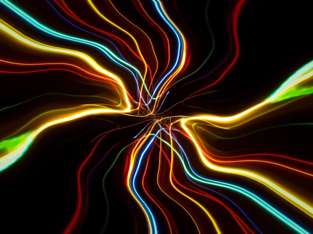 an abstract image of colorful lines in the dark