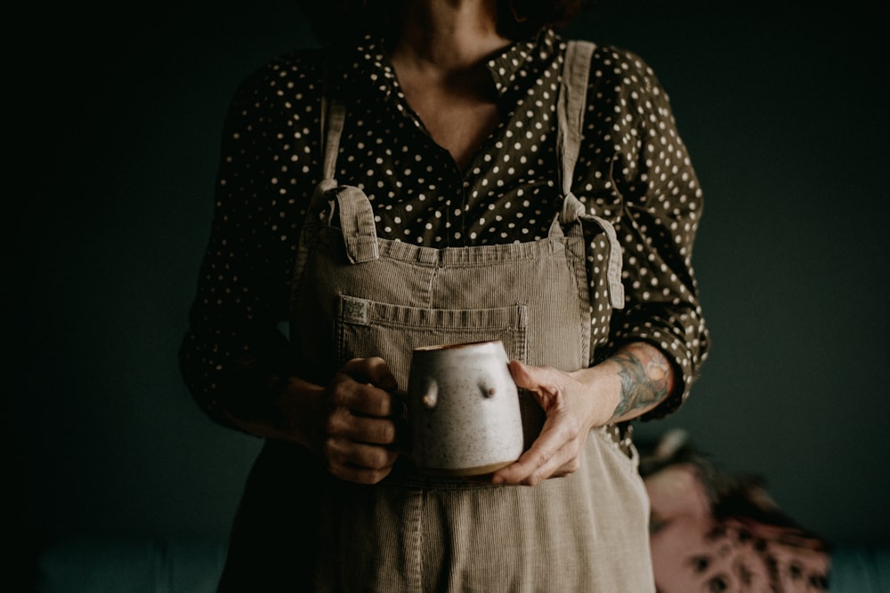 a woman holding a cup in her hands