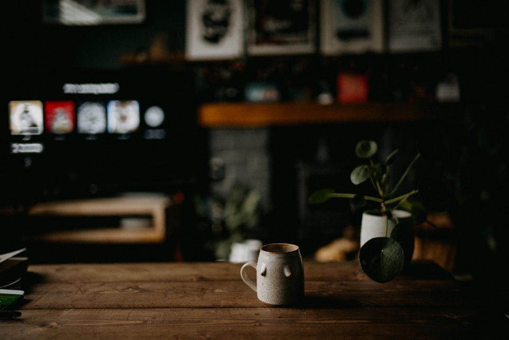 a coffee cup sitting on top of a wooden table