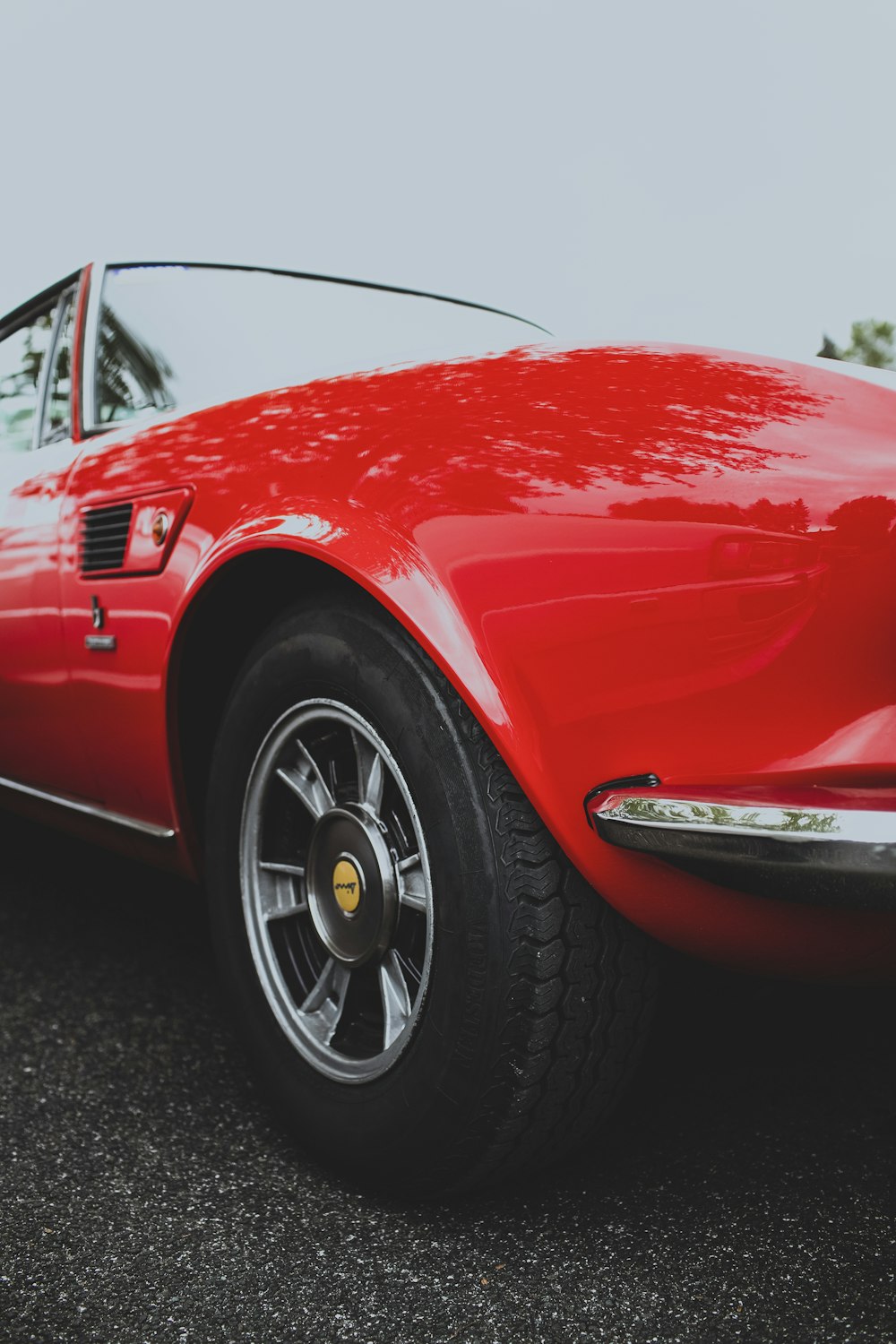 a red sports car parked on the side of the road