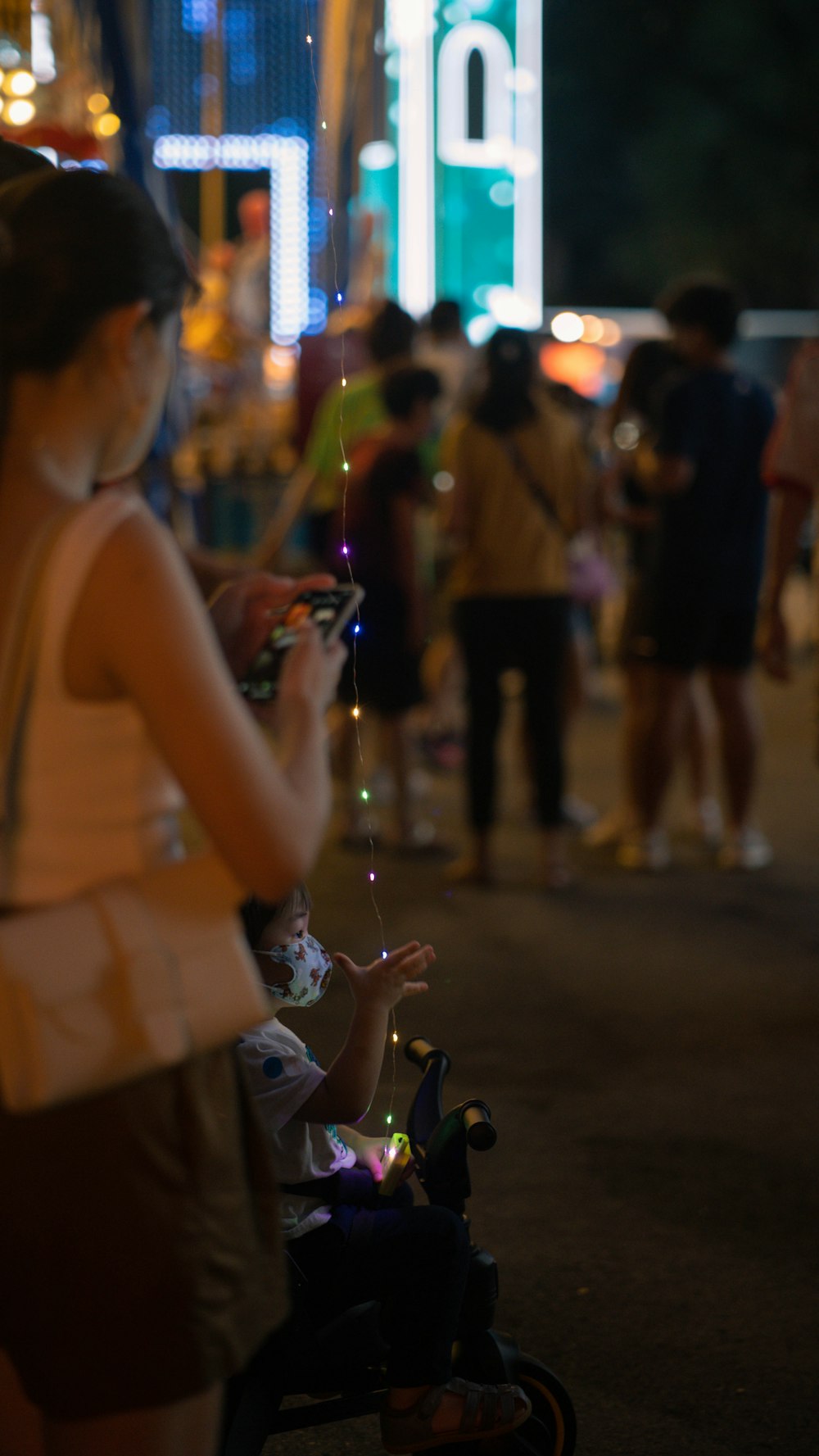 a group of people standing on a street at night