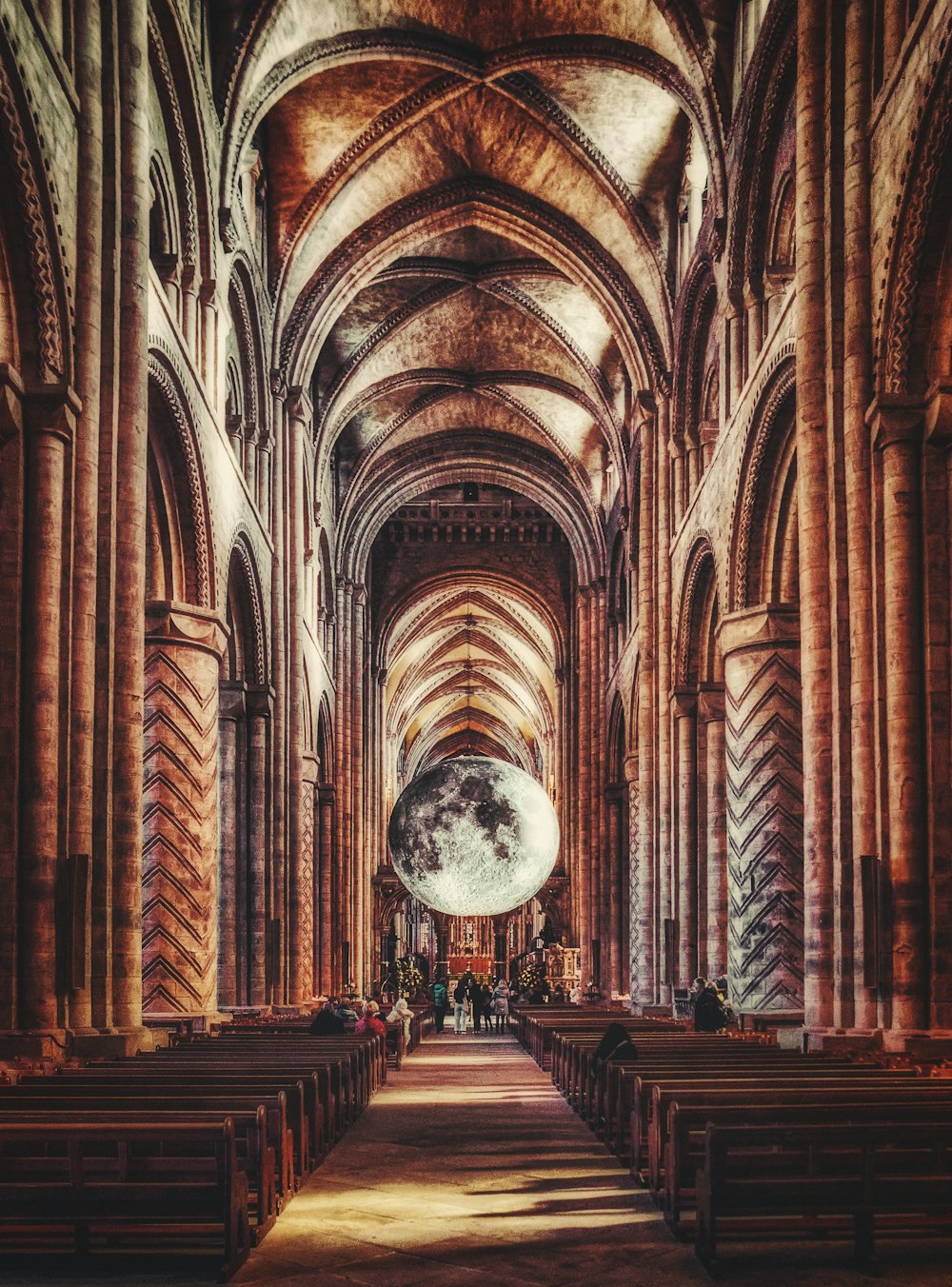 a large cathedral with rows of pews and arches