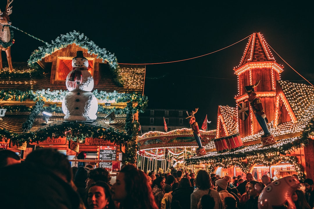 a crowd of people standing around a christmas display