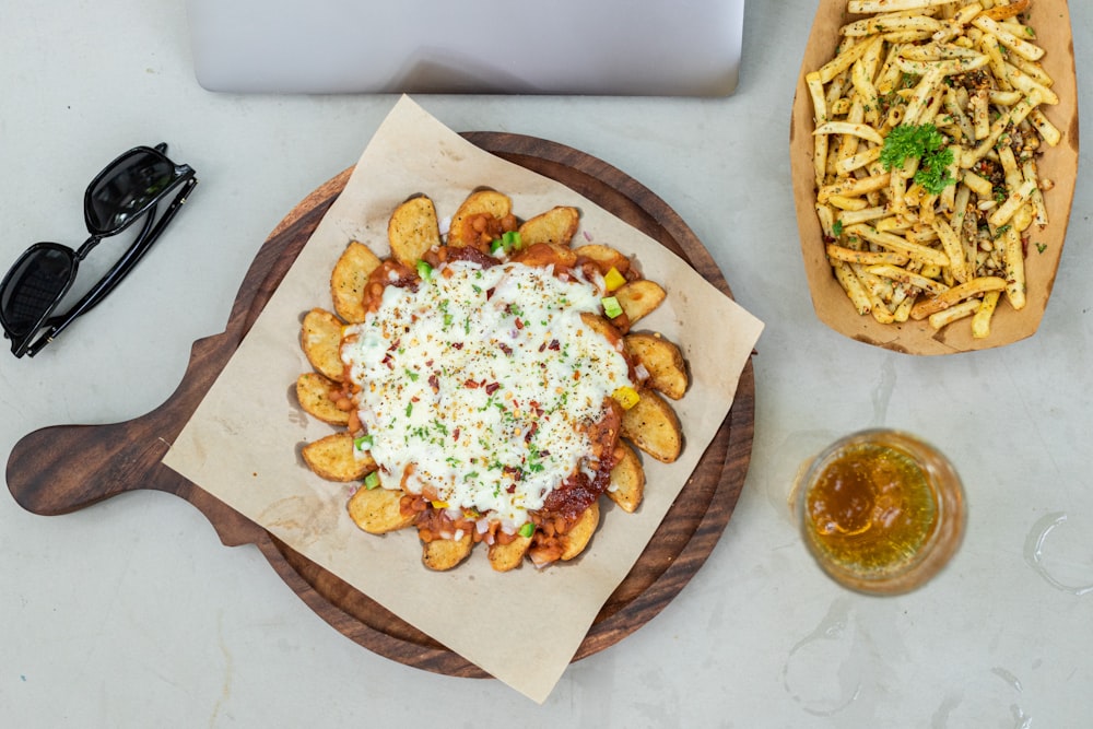 a plate of french fries and a pizza on a table