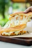 a person is holding a piece of food in their hand