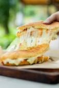 a person is holding a piece of food in their hand