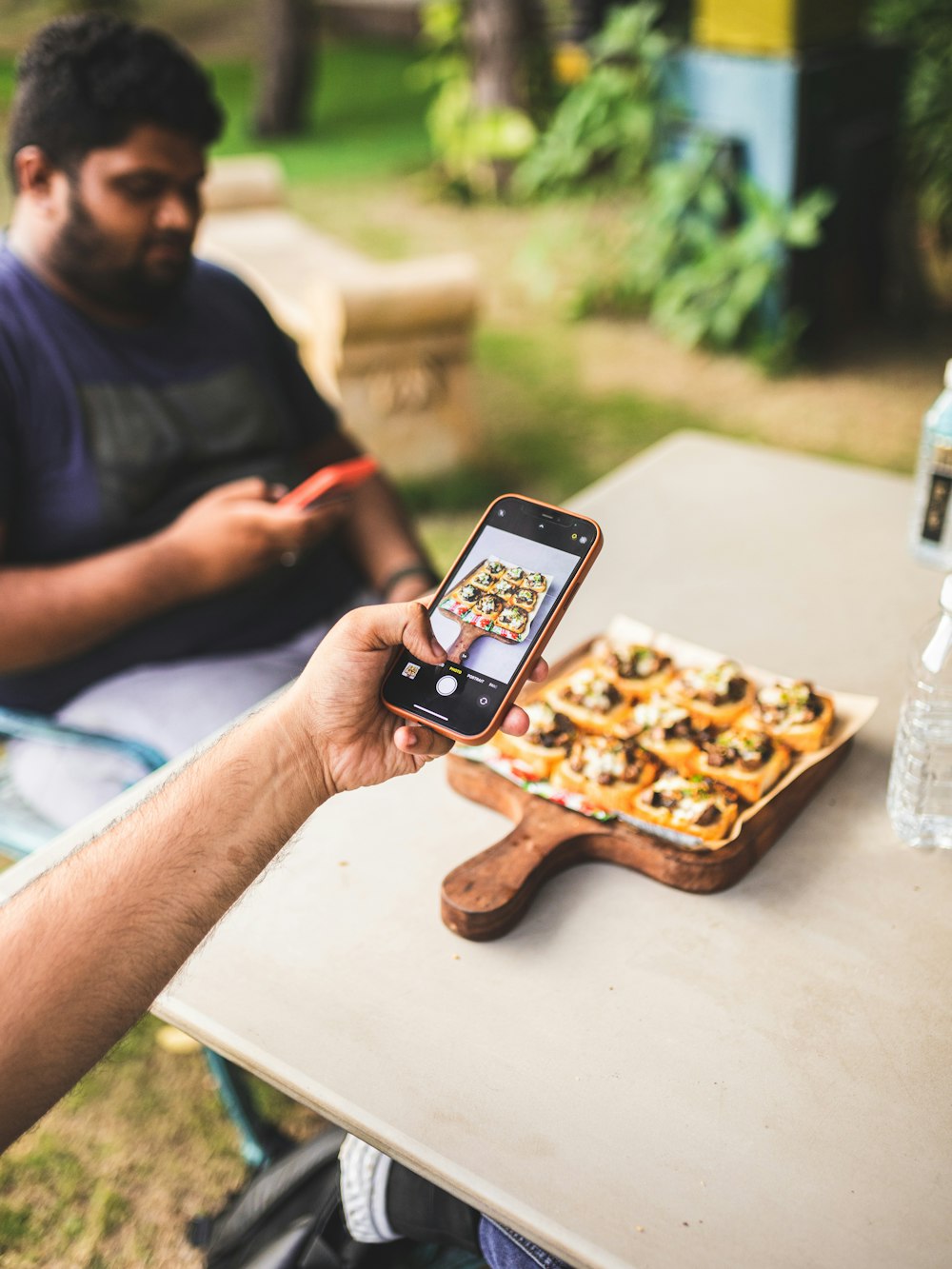 a man sitting at a table with a cellphone