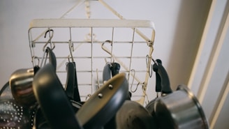 A sturdy hanging pot rack displaying various pots and pans in a cozy kitchen.