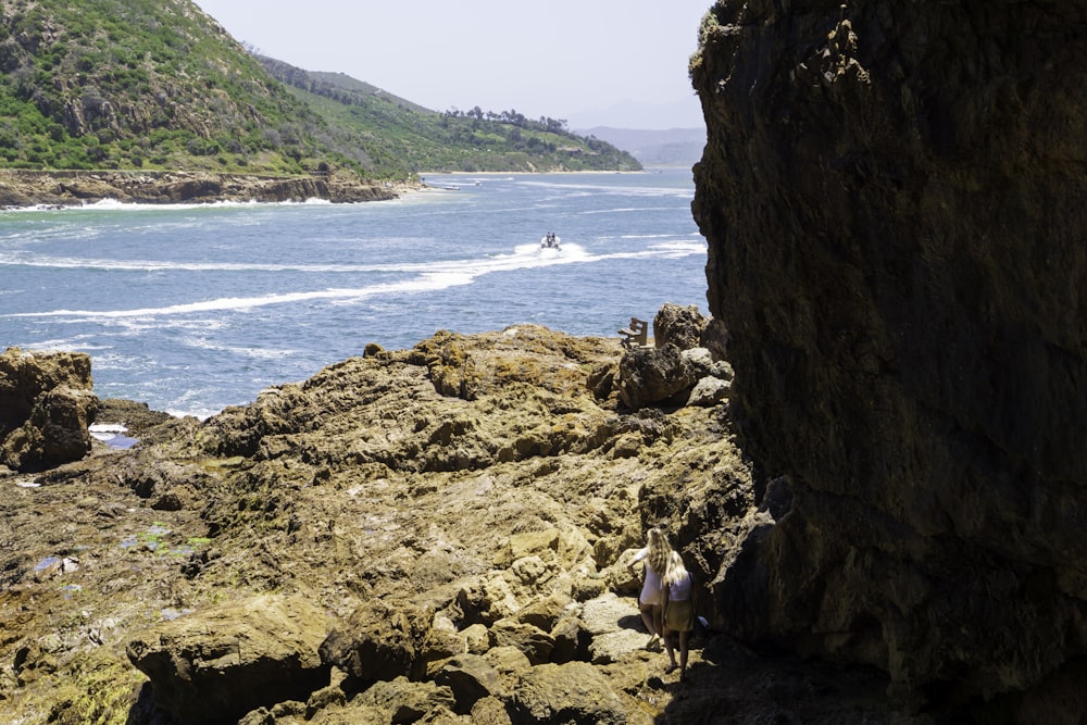 a rocky cliff overlooks a body of water