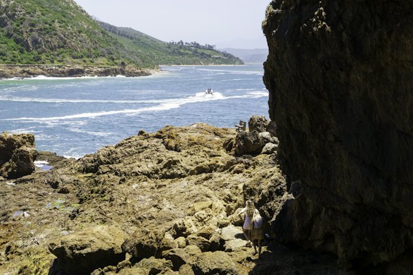 A rocky cliff overlooks a body of water — Garden Route, South Africa