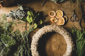 a wooden table topped with oranges and herbs