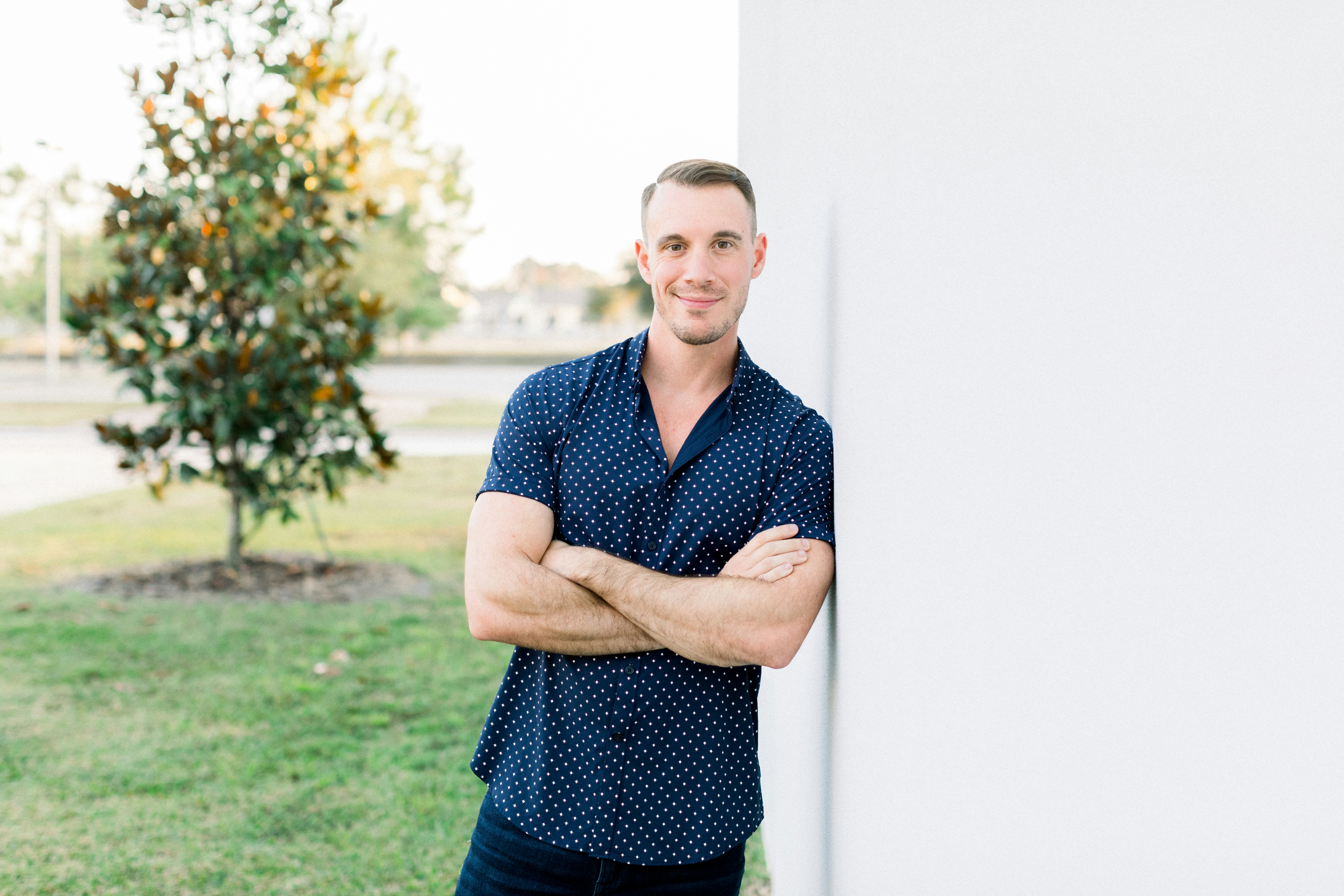 great photo recipe,how to photograph alex sanfilippo, the founder of podpros, confidently leaning against a wall with arms crossed out on the lawn. model alex sanfilippo, the founder of podpros @ podpros.com; a man leaning against a wall with his arms crossed