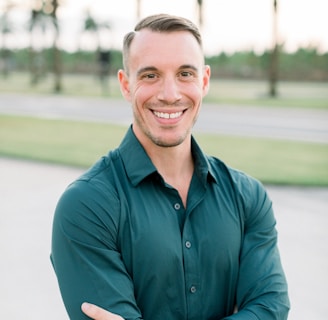 a man in a green shirt is posing for a picture