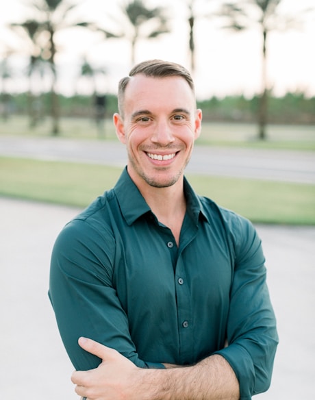 a man in a green shirt is posing for a picture