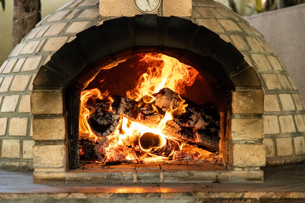 a brick oven with fire burning inside of it