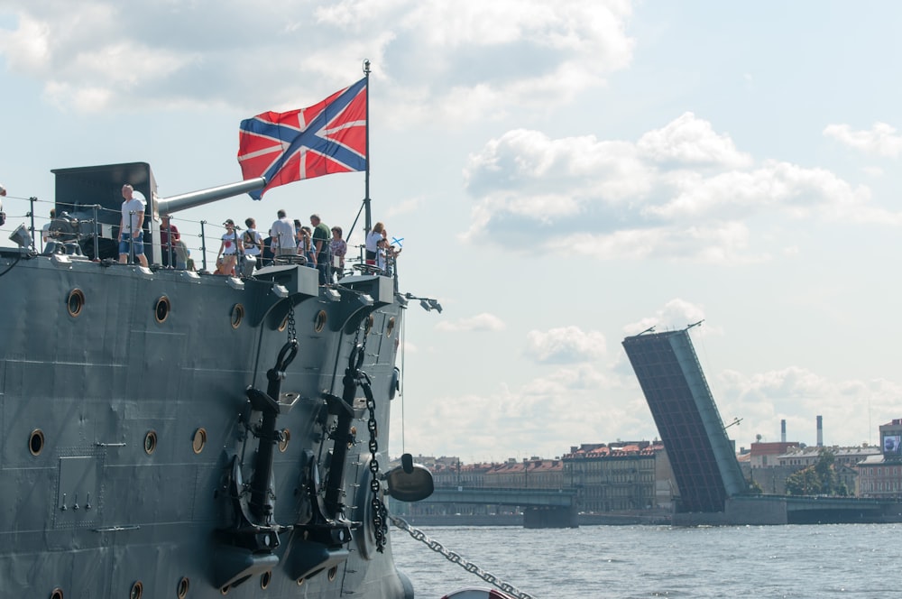 a large battleship with a flag on top of it