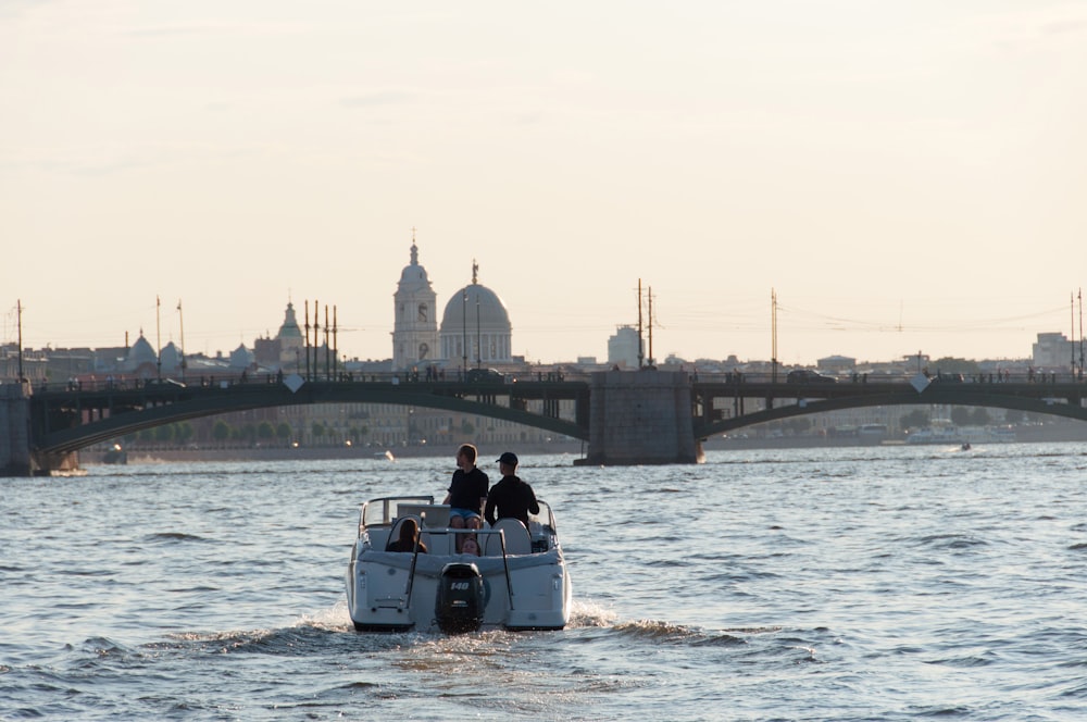 a couple of people riding on the back of a boat