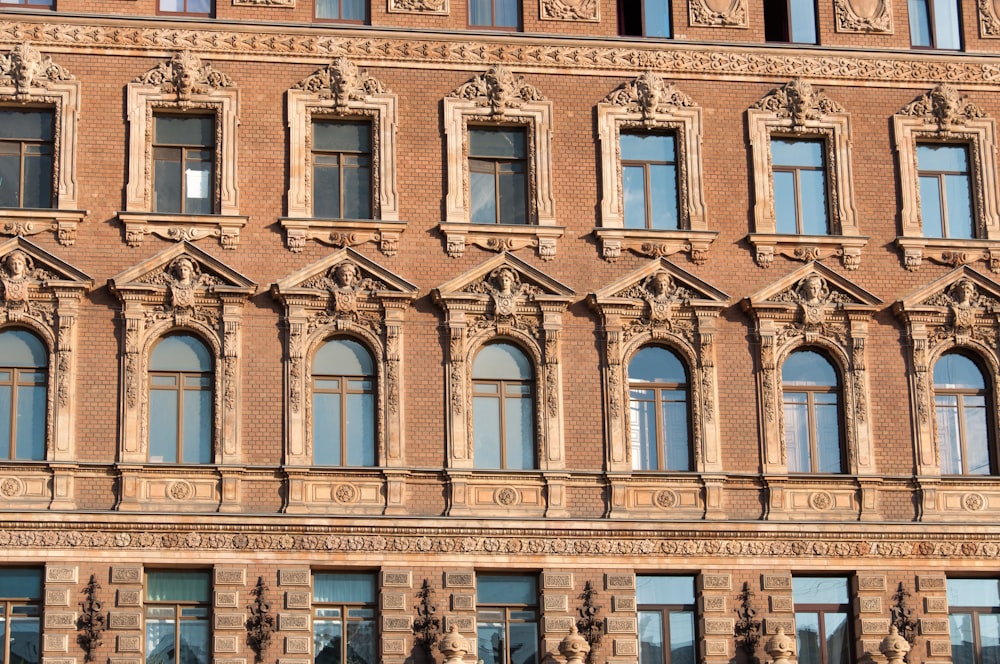 a building with many windows and a clock on the front of it