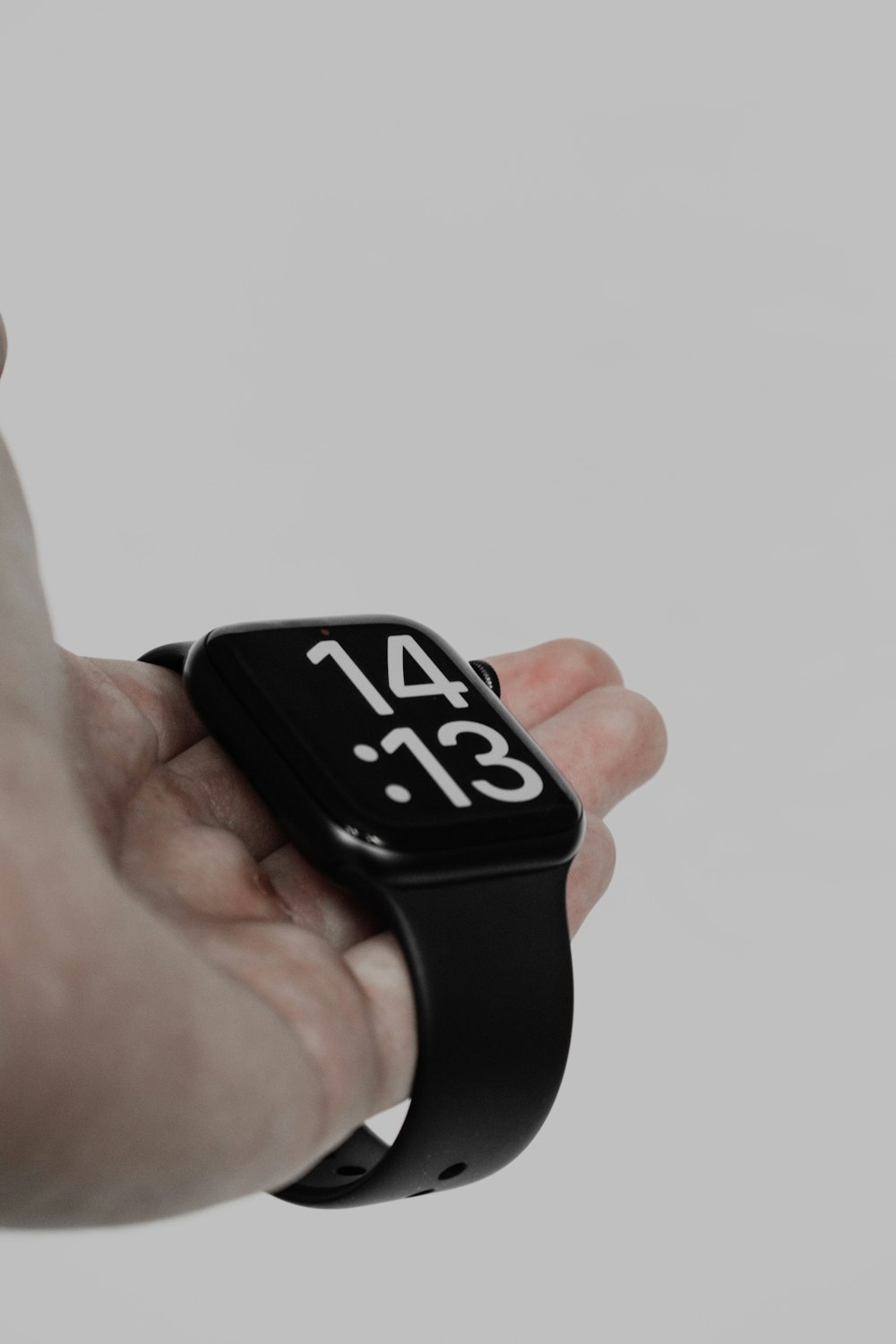 a person holding a smart watch in their hand