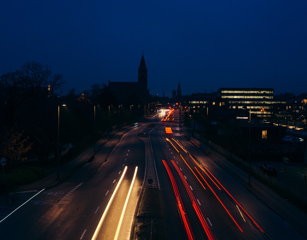 a city street filled with lots of traffic at night