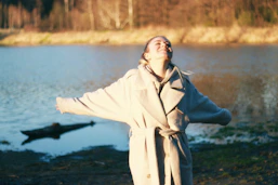a person standing next to a body of water