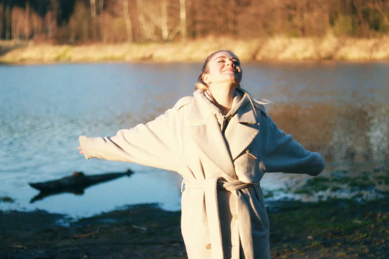 a person standing next to a body of water